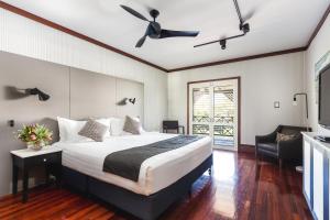 
a bedroom with a large bed and a large window at Cable Beach Club Resort & Spa in Broome
