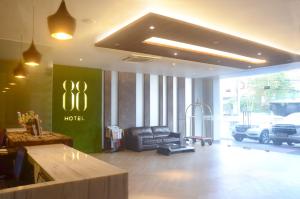 a hotel lobby with a couch and a car at Hotel 88 Embong Kenongo - Kayun By WH in Surabaya