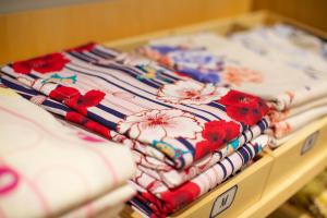 a group of quilts sitting on a table at HOTEL AMANEK Kyoto Kawaramachi Gojo in Kyoto