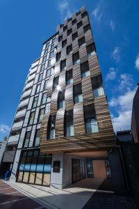 a tall building with windows on the side of it at HOTEL AMANEK Kyoto Kawaramachi Gojo in Kyoto