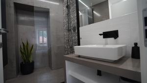 a bathroom with a white sink and a mirror at Al Castello in Dolceacqua +34 photos