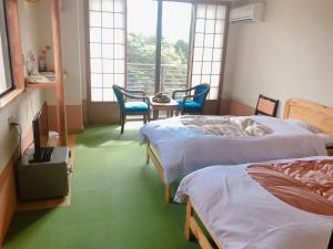 Postel nebo postele na pokoji v ubytování Hotel New Ohruri