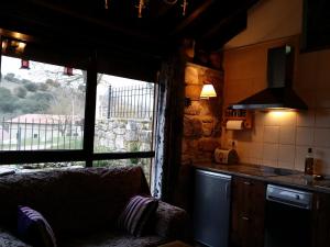 a kitchen with a couch and a window in a room at Casa Rural Villamoronta in La Rad