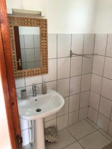 a bathroom with a sink and a mirror at LeSaintCyr in Sainte-Rose