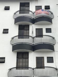 a white building with spiral balconies on the side of it at Super Budget 3 Rooms Apartment @ Brinchang Town in Brinchang