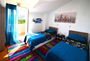a bedroom with two beds and a window at VILLA DINJA in Gizdavac +57 photos
