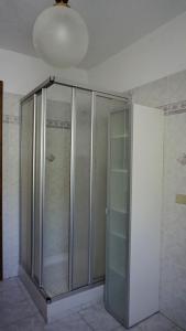 a glass shower in a room with a ceiling at Maison Borbey in Aosta