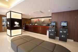 a hotel lobby with two atm machines and a counter at Lantana Osaka in Osaka