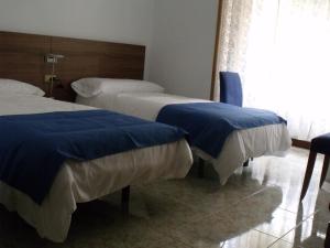 Un pat sau paturi într-o cameră la Pensión Arroniz