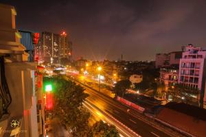 a city at night with traffic lights and buildings at Golden Hotel in Hanoi