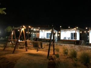 a playground at night with a building with lights at Rincón del Corazón in Valle de Guadalupe