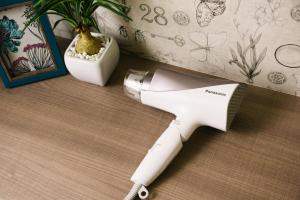 a hair dryer sitting on a counter next to a plant at HOTEL Sui HARUYOSHI in Fukuoka