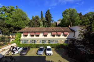 a group of cars parked in front of a house at Hotel Villa Carlotta in Florence