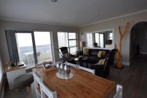 a living room with a table and a couch at Apartment Dolphin House in Hermanus