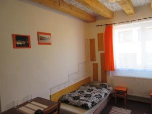 a small bedroom with a bed and a window at Penzion Shamrock in Třebíč