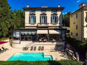 a large white house with a large window at Hotel Villa Carlotta in Florence