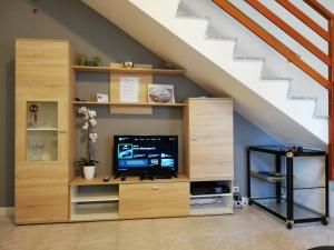 a entertainment center under the stairs with a flat screen tv at Villa Malu in Anzio