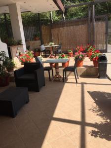a patio with a table and chairs and flowers at Agriturismo da Regina in Tramonti