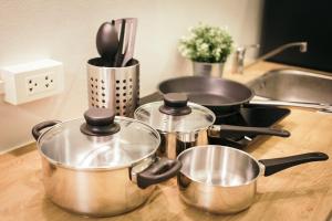three pots and pans sitting on a kitchen counter at T1 Large Studio Full kitchen 100m. to BTS in Bangkok