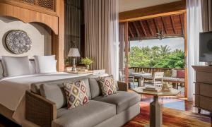 a bedroom with a bed and a couch and a patio at Four Seasons Resort Langkawi in Tanjung Rhu +37 photos