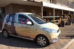 a small car parked in front of a building at Mon Reve in Lephalale