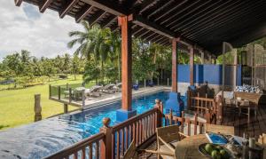 a pool at a resort with a table and chairs at Four Seasons Resort Langkawi in Tanjung Rhu
