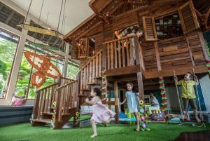 a group of children playing in a tree house at Four Seasons Resort Langkawi in Tanjung Rhu