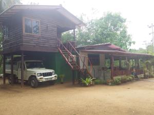 un camion parcheggiato di fronte a una piccola casa di Pidurangala View Home Stay a Sigiriya