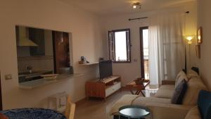 a living room with a couch and a tv at Sea Mountain in Atlántico in Costa Del Silencio