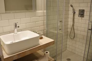 a bathroom with a sink and a shower at YOU & CO. Saler Beach Boutique in Valencia
