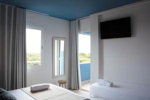 a bedroom with two beds and a flat screen tv at YOU & CO. Saler Beach Boutique in Valencia