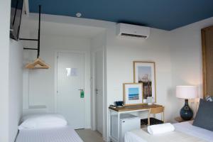 a bedroom with two beds and a table with a picture at YOU & CO. Saler Beach Boutique in Valencia