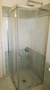 a shower with a glass door in a bathroom at Villa Malu in Anzio +33 photos