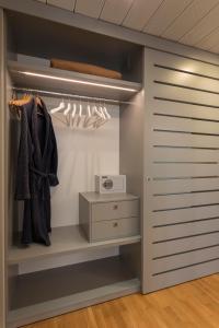 a dressing room with a closet with a dresser at Suite Erica Lignano Hotel in Lignano Sabbiadoro