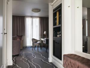 a hotel room with a desk and a room at Britannia Hotel in Trondheim
