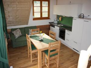 a kitchen and dining room with a table and a couch at Urlaub im Herrenholz in Zell am Harmersbach