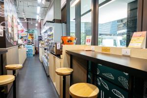 a restaurant with a counter and stools in a store at B2 Large + Comfort full kitchen near MRT Bangson in Bangkok