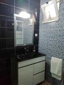 a bathroom with a sink and a mirror at Villa Gonçalo in Caldas da Rainha