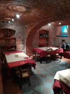 a dining room with tables and chairs in a building at Hotel Palazzo Di Mezzo in Carrù