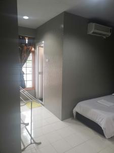 a bedroom with a bed and a staircase in it at Riverbank Dungun Guesthouse & Cafe in Dungun