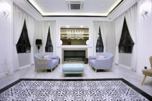a living room with two chairs and a fireplace at Stanton Hotel in Kota Kinabalu