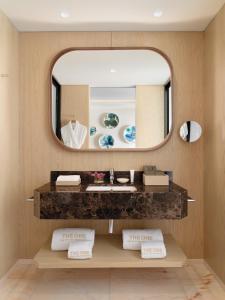 a bathroom with two sinks and a mirror at The One Palácio da Anunciada in Lisbon