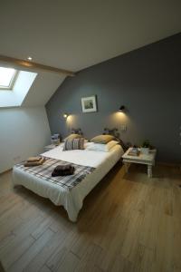 a bedroom with a large bed and a table at L'Eyssaben Appartement de grand standing à Serre-Chevalier in Le Monêtier-les-Bains +7 photos