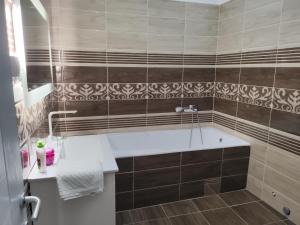 a bathroom with a tub and a sink at Luna in Prokuplje
