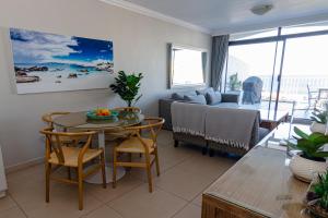 sala de estar con mesa y sofá en 20 Marine Terraces, en Durban