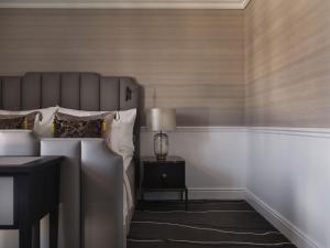 a bedroom with a bed and a lamp on a nightstand at Britannia Hotel in Trondheim +30 photos