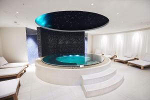 a wellness center with a tub in the middle of a room at Britannia Hotel in Trondheim