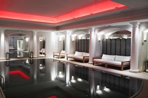 a room with a pool of water with couches and chairs at Britannia Hotel in Trondheim