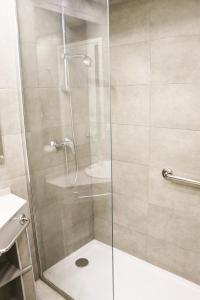 a shower with a glass door in a bathroom at Apartamentos Tamarindos Peñiscola in Peniscola