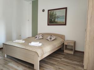 a bedroom with a bed with two towels on it at Luna in Prokuplje